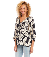 Load image into Gallery viewer, Achieve true effortless style with the Karen Kane blouson sleeve top. Featuring billowy sleeves and a relaxed fit, this top is perfect for creating a chic, polished look when paired with jeans.  Viscose fabrication ensures all-day comfort and breathability. Colors- Black and light tan. Split neck with ties. Crepe fabrication. Blouson sleeve with wide cuff. Tropical palm leaf print. Straight hemline. Pullover style.
