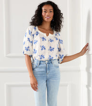 Load image into Gallery viewer, Lightweight cotton gives a breezy quality to this peasant top detailed with charming floral embroidery. It&#39;s finished with statement-making puff sleeves. Colors- Off white and blue. Short sleeve. Button down. Floral embroidery.
