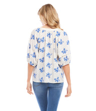 Load image into Gallery viewer, Lightweight cotton gives a breezy quality to this peasant top detailed with charming floral embroidery. It&#39;s finished with statement-making puff sleeves. Colors- Off white and blue. Short sleeve. Button down. Floral embroidery.
