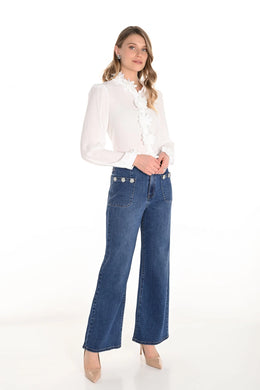 Woman wearing a white blouse and blue jeans against a white background.