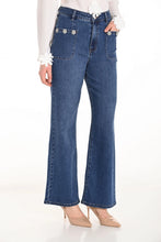 Load image into Gallery viewer, Woman wearing a white blouse, blue jeans and heels against a white background.
