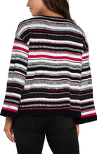 Load image into Gallery viewer, This stylish sweater seamlessly blends timeless elegance with modern flair, featuring a boat neckline that highlights the collarbone and elongates the neck. The captivating striped design and subtle hints of Ruby add a touch of refinement, making it perfect for both casual outings and refined occasions.
