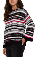 Load image into Gallery viewer, This stylish sweater seamlessly blends timeless elegance with modern flair, featuring a boat neckline that highlights the collarbone and elongates the neck. The captivating striped design and subtle hints of Ruby add a touch of refinement, making it perfect for both casual outings and refined occasions.
