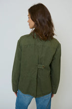 Load image into Gallery viewer, Woman wearing green shacket and blue jeans against a neutral background.
