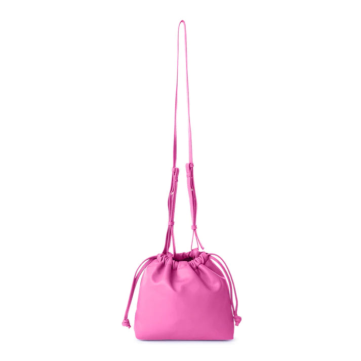 This stylish bucket bag is spacious, perfect for carrying all the essentials when you're on the go! It also features a removable and adjustable strap for easy carrying. Constructed from ultra-soft vegan leather, this bag is sure to have heads turning!  Color- Fuchsia. Removable strap. Interior slit pocket. Vegan leather. Drawstring closure. Measurements--11.5’’ x 3’‘x 6’