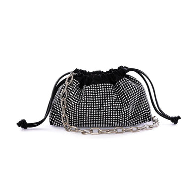 This spacious bag is perfect for carrying all of your essentials when you're on the go! Constructed with luxurious vegan leather, you can remove the chain for a chic, minimalistic clutch look. Effortlessly transition your look from day to night with this stylish bag.  Color- Black. Drawstring closure.  Crystals. Removable chain. Interior slit pocket. Vegan leather.