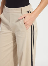 Load image into Gallery viewer, Close-up of beige pants with black stripes on a plain background.
