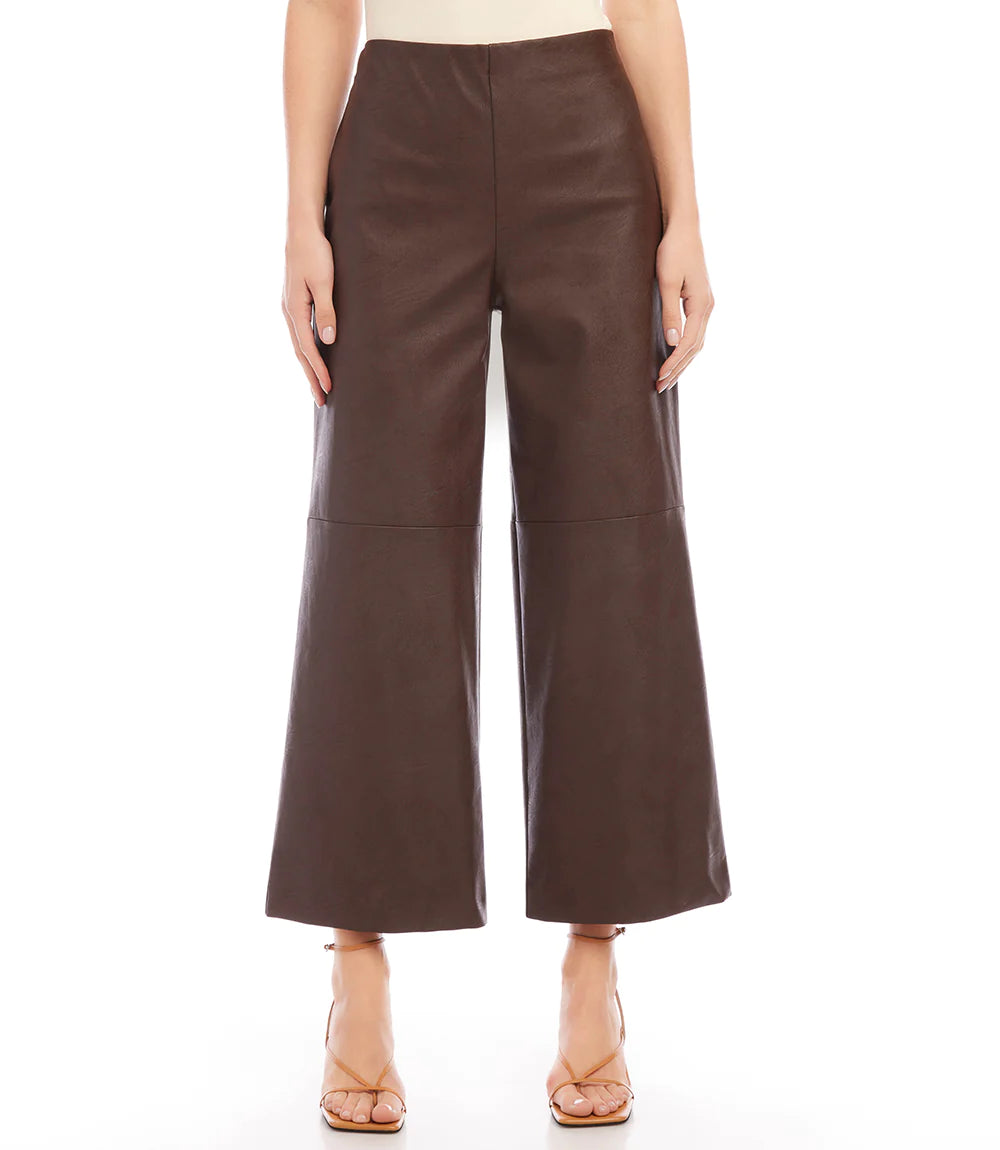 Introducing our contemporary and sustainable Cropped Vegan Leather Pants, tailored for fashion-conscious individuals who prioritize the environment. Constructed from premium materials, these pants offer the same modern look of leather while ensuring cruelty free.  Color- Brown. Wide-leg. Elasticized waistband. Invisible side zipper. Fabric - 50% Viscose 50% Polyurethane.