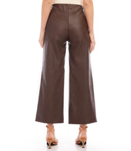 Load image into Gallery viewer, Introducing our contemporary and sustainable Cropped Vegan Leather Pants, tailored for fashion-conscious individuals who prioritize the environment. Constructed from premium materials, these pants offer the same modern look of leather while ensuring cruelty free.  Color- Brown. Wide-leg. Elasticized waistband. Invisible side zipper. Fabric - 50% Viscose 50% Polyurethane.
