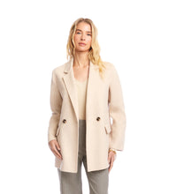 Load image into Gallery viewer, Woman wearing an oatmeal overcoat over an oatmeal v-neck top and striped pants against a white background.
