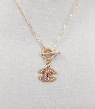 Load image into Gallery viewer, This vintage CC zipper pull necklace offers a delightful combination of pearl and crystal. Ideal for any ensemble, its delicate, feminine design is sure to turn heads.
