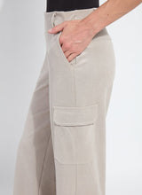 Load image into Gallery viewer, Close-up of model wearing soft taupe shiny cargo pants against a white background.
