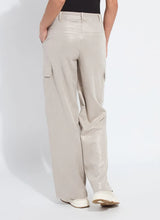 Load image into Gallery viewer, Model wearing soft taupe shiny cargo pants, black top and white sneakers against a white background.
