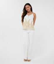 Load image into Gallery viewer, The EsQualo Clady Camisole is a stunning piece designed for effortless elegance. This embroidered camisole features a delicate leaf pattern interwoven with shimmering lurex, adding a touch of sophistication. The playful wooden buttons and adjustable straps ensure a comfortable and customizable fit. This lovely top, on its own or under a jacket, offers a lightweight and breathable feel, perfect for warm-weather styling.

