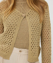 Load image into Gallery viewer, Elevate your wardrobe with the Cira Cardigan Button Lurex by EsQualo. This luxurious gold cardigan features a shimmering lurex fabric, a classic button-front design, and a chic, versatile fit perfect for layering. Whether dressing up or keeping it casual, this stylish knit adds a touch of elegance to any outfit. Shop now for a timeless, fashion-forward look.
