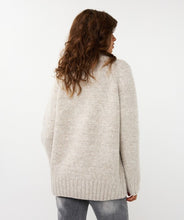 Load image into Gallery viewer, Model wearing a light sand sweater and gray pants against a white background.
