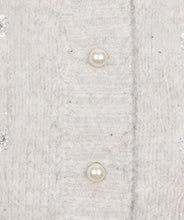 Load image into Gallery viewer, Close-up of a textured fabric surface with pearl-like buttons and small sparkle embellishments.
