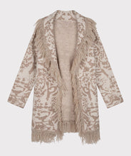 Load image into Gallery viewer, This animal print cardigan with fringe detailing is classic and stylish. The cardigan features a belted waist that adds visual interest. Whether you dress it up or pair it with denim, it&#39;s the ideal accessory for cooler weather where a jacket or coat might be too heavy.  Color-Bisquit; Light tan and white. Animal print. Belted closure. Fringe detailing all around.  Longer design.  Fabric - 85% Acrylic. 15% Polyester.
