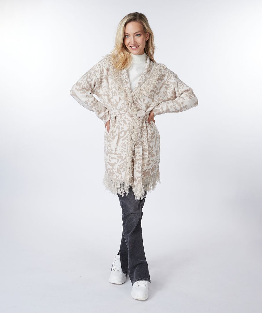 This animal print cardigan with fringe detailing is classic and stylish. The cardigan features a belted waist that adds visual interest. Whether you dress it up or pair it with denim, it's the ideal accessory for cooler weather where a jacket or coat might be too heavy.  Color-Bisquit; Light tan and white. Animal print. Belted closure. Fringe detailing all around.  Longer design.  Fabric - 85% Acrylic. 15% Polyester.