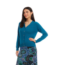 Load image into Gallery viewer, Woman wearing a teal cardigan and colorful skirt against a white background.
