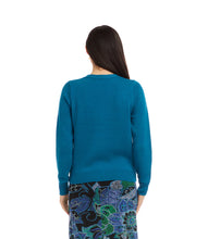 Load image into Gallery viewer, Woman wearing a teal cardigan and colorful skirt against a white background.
