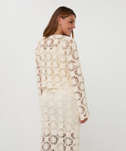 Load image into Gallery viewer, Woman wearing a natural color crochet cardigan and matching skirt against a white background.
