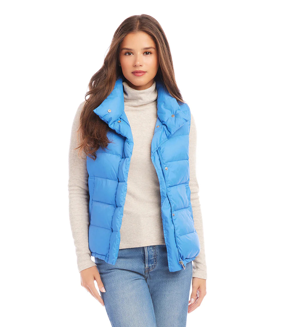 This versatile outerwear option features convenient snaps and a zipper for easy wear and adds just the right amount of insulation when needed. Stand out in style and step into the weather with this cute and feminine vest. Color - Chambray. Length: 24 5/8 inches (size M) Stand collar. Sleeveless. Drawcord-toggle waist. Fabric - Puffer: 100% Nylon.