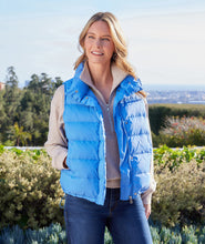 Load image into Gallery viewer, This versatile outerwear option features convenient snaps and a zipper for easy wear and adds just the right amount of insulation when needed. Stand out in style and step into the weather with this cute and feminine vest. Color - Chambray. Length: 24 5/8 inches (size M) Stand collar. Sleeveless. Drawcord-toggle waist. Fabric - Puffer: 100% Nylon.
