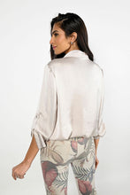 Load image into Gallery viewer, The Charise Champagne Blouse is made of a luxurious satin fabric that features chic sequin sparkle pockets. It also includes a button-down design with tab roll sleeves, as well as an elastic waistband with ties for an ideal fit.  Color- Champagne. Sequin pockets. Roll tab sleeves. Button down. Collared.
