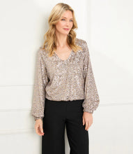 Load image into Gallery viewer, This stunning top offers unparalleled comfort and shimmer. A champagne-colored sequin design offers a stunning visual aesthetic. Wear it to events to make an impression without sacrificing comfort. Create a sophisticated look when paired with black trousers or a chic look when styled with cream or blue denim.  Color- Champagne. V-neck. Elasticized hem. Lined. Fabric -Sequin Mesh: 90% Nylon. 10% Spandex. Care -Dry clean.
