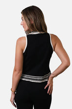 Load image into Gallery viewer, Woman wearing sleeveless black top with black and cream crochet trim and black pants against a white background.
