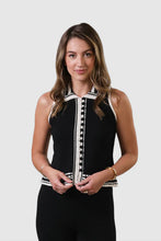 Load image into Gallery viewer, Woman wearing sleeveless black top with black and cream crochet trim and black pants against a white background.
