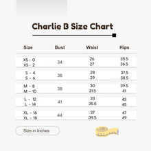 Load image into Gallery viewer, A size chart graphic titled 'Charlie B Size Chart' with a table listing sizes XS-0 through XL-18, bust, waist, and hips in inches. A small measuring tape icon appears at the bottom right on a light gray background.
