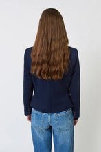 Load image into Gallery viewer, Woman wearing a navy blazer with a striped dickey and blue jeans against a plain background.
