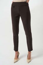 Load image into Gallery viewer, Model wearing mocha slim fitting pants and off-white heels against a white background.
