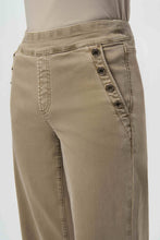 Load image into Gallery viewer, Close-up of model wearing warm taupe jeans with button detailing on pockets against a white background.
