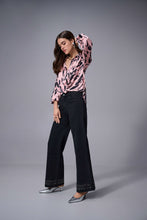 Load image into Gallery viewer, Woman wearing a pink blouse, dark grey denim jeans and heels against a white background.
