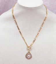 Load image into Gallery viewer, Experience a true rarity with this Clemantine necklace featuring a beautiful Chanel vintage teardrop zipper pull adorned with dazzling crystals. The teardrop design is complemented by a white teardrop base and a striking CC logo at its center. Don&#39;t miss the chance to own this stunning and one-of-a-kind piece.
