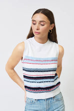 Load image into Gallery viewer, Woman wearing a sleeveless blue and multi stripe top and blue jeans against a white background.
