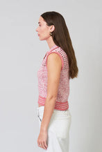 Load image into Gallery viewer, Woman wearing a sleeveless pink crop polo top and white pants against a grey background.
