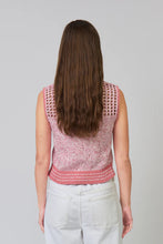 Load image into Gallery viewer, Woman wearing a sleeveless pink crop polo top and white pants against a grey background.
