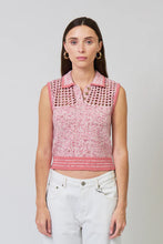 Load image into Gallery viewer, Woman wearing a sleeveless pink crop polo top and white pants against a grey background.
