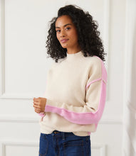 Load image into Gallery viewer, Woman wearing a sand and pink colorblock sweater and jeans against a white wall.

