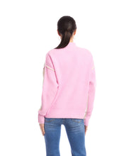 Load image into Gallery viewer, Woman wearing a sand and pink colorblock sweater and jeans against a white backround.
