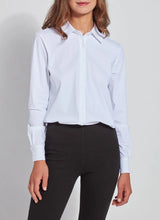 Load image into Gallery viewer, Woman wearing a white shirt and black pants on a gray background.
