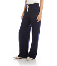 Load image into Gallery viewer, Navy blue wide-leg pants with a cream trim and drawstring and tennis shoes worn by a model against a white background.
