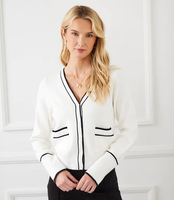 This versatile cardigan effortlessly blends both comfort and elegance with its contrasting trim and convenient patch pockets. Ideal for a casual day out or a polished office look, this essential layering piece adds a touch of sophistication to any ensemble.