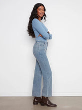 Load image into Gallery viewer, Woman standing sideways wearing a light blue corduroy pant and light blue top and brown boots against a white wall.
