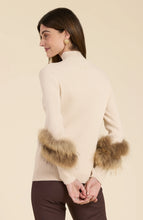 Load image into Gallery viewer, Elevate your turtleneck with a hint of faux fur that rivals the appearance of real fur. This distinctive touch transforms a basic item into a versatile piece suitable for any event, whether during the day or at night. Dress up with a skirt or trouser or show off a modern, casual vibe with your favorite denim.
