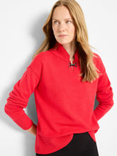 Load image into Gallery viewer, Woman wearing a red sweater and black pants against a white background.
